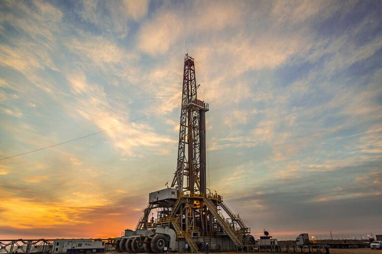 Oil drilling rig at dawn